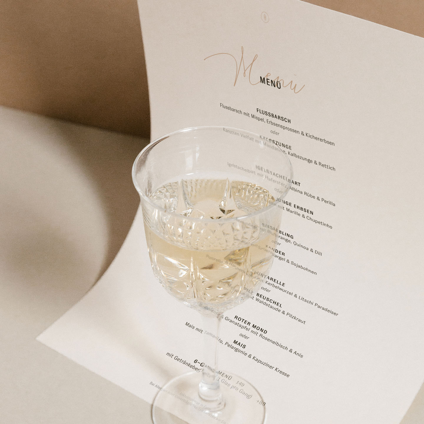 bright photography of a wine glass on top of the daily menu