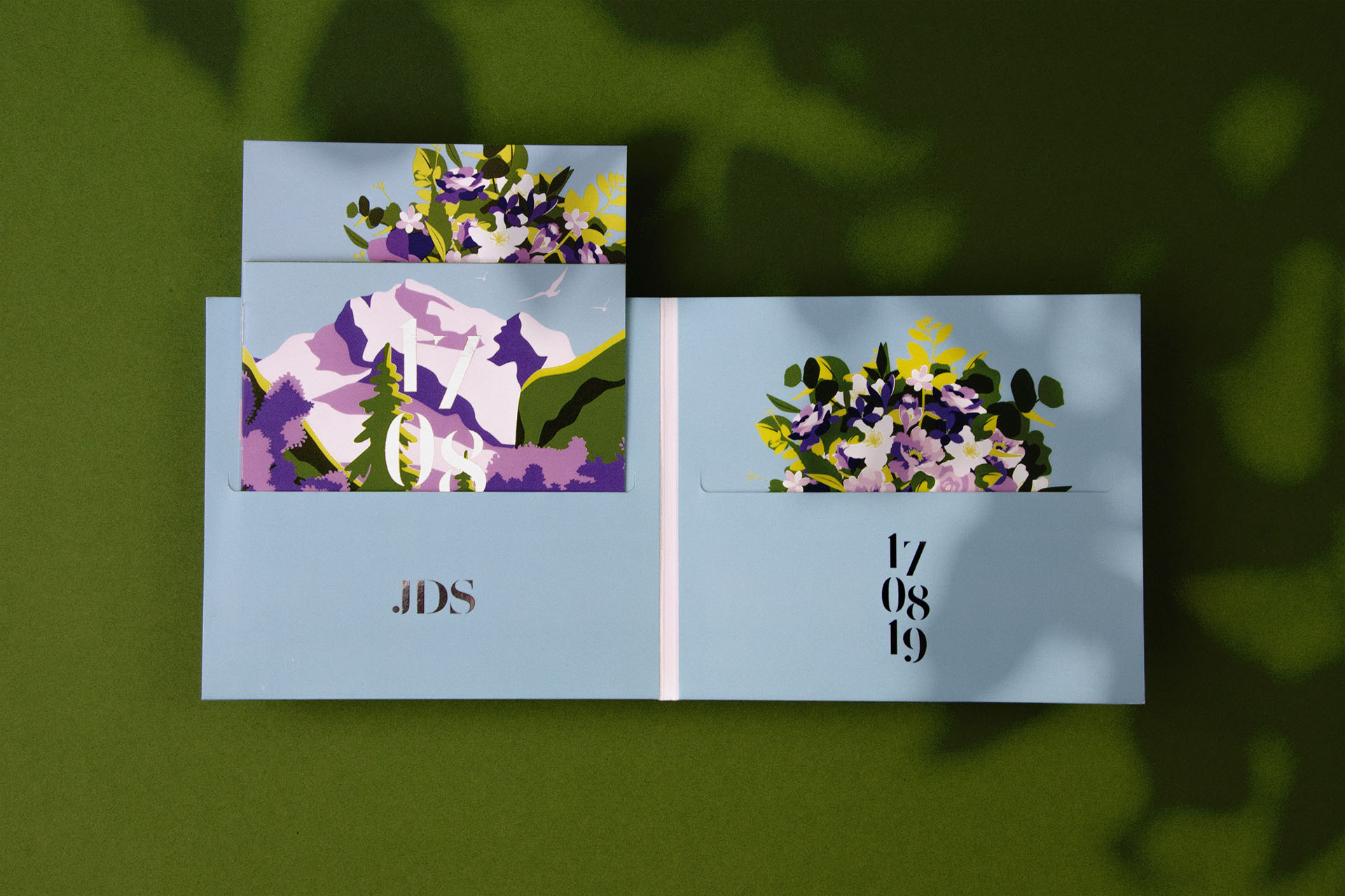 different parts of a wedding invitation with a booklet, CD-case and illustrations